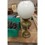 A Victorian brass oil lamp With opaque glass shade and a boxed Tilley lamp.