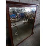 A Victorian walnut framed overmantle mirror Having a rectangular bevelled mirrored plate.