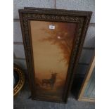 A pair of prints depicting stags within gilt embellished frames.