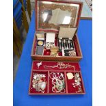 A wooden jewellery box Containing a large quantity of costume jewellery, a cased set of silver