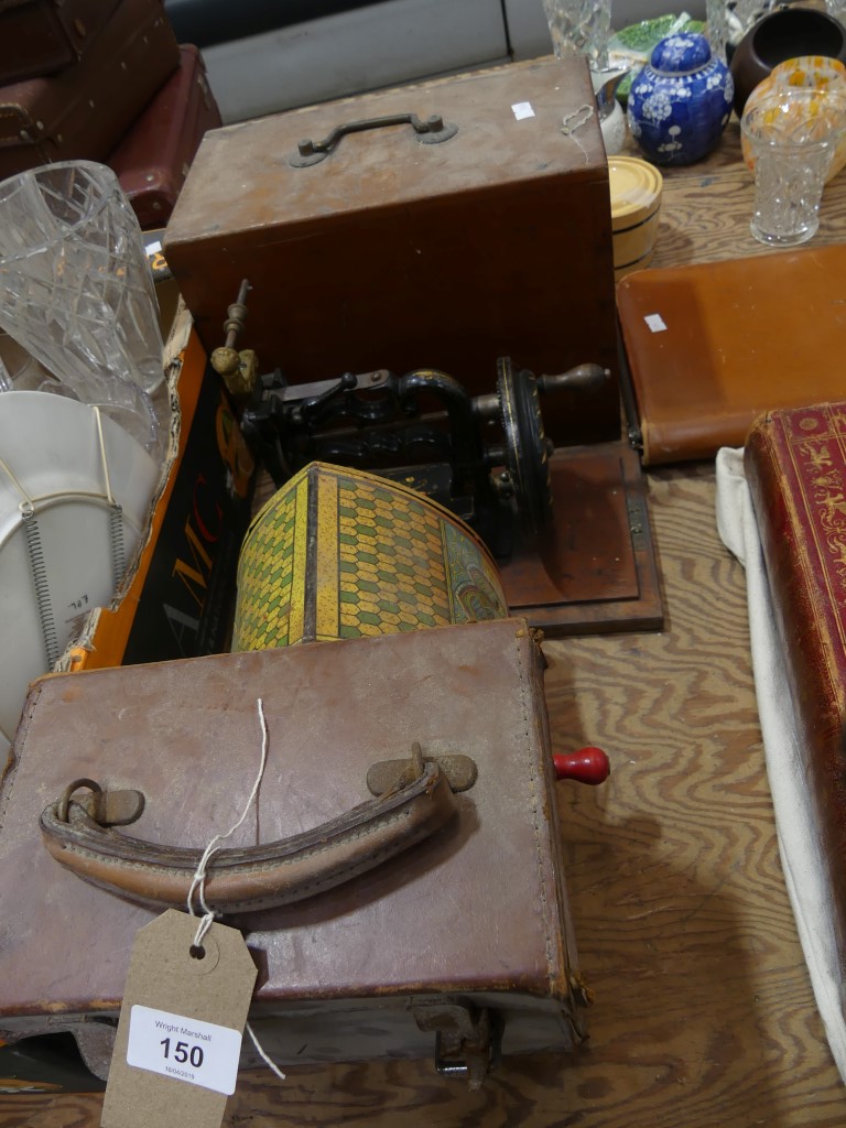 An early 20th century cased sewing machine A vintage tin plate organ soundbox , a leather cased