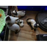 A collection of three Beswick Siamese cats Including kitten example, one standing up example and one