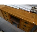 A Rustic oak twin pedestal desk with conforming stool.
