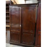 A 19th Century mahogany two door wardrobe Having a moulded cavetto cornice above two panelled