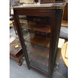 A French 19th Century marble top vitrine Having an openwork brass galleried top enclosing a marble