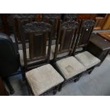 A set of six 18th Century oak panel back dining chairs on bobbin turned supports and cross