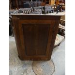 A 19th Century oak and crossbanded flat front hanging corner cupboard.