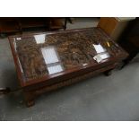 An impressive Thai carved hardwood coffee table The rectangular coffee table with a glass panel