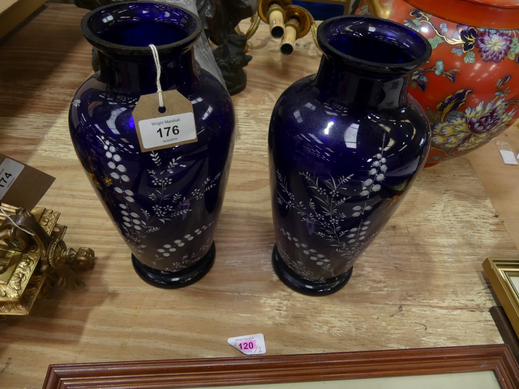 A pair of Victorian blue overlay glass vases The vases of shouldered form, with white paint
