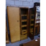 An 1940's two door bow front maple gents wardrobe With a fitted interior