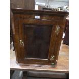 A reproduction Georgian style oak hanging corner cupboard.