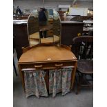 A Mid 20th Century half moon dressing table with a single drawer above two cupboard doors.