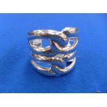 A cuff bangle Of openwork design, designed as two pairs of overlapping loops, stamped 925CMV MEXICO,
