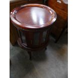 A Reproduction hardwood bijouterie cabinet on slender curvilinear legs.