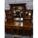 A late Victorian walnut mirror back sideboard With an arrangement of three drawers over four