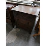 A Reproduction oak chest with a carved drawer above two drawers.