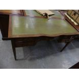 A good quality reproduction writing desk by Bevan Funnel. The serpentine leather inset top above