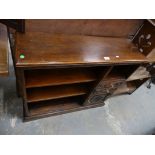 A Reproduction oak freestanding bookcase with an arrangement of open shelves , short drawers and a