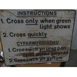 An English and Welsh painted metal railway crossing sign.