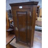 A Reproduction Georgian style oak hanging corner cupboard.