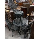 A painted metal patio or garden set comprising circular table and four chairs.