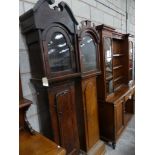 A primitive oak longcase clock case, early 17th Century Having a twin swan neck pediment above a