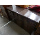 A Jay Cee reproduction oak sideboard With three drawers and three cupboard doors