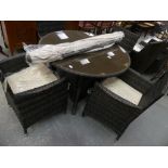 A " Made Aware" simulated wicker six piece patio set comprising circular glass top table, four tub