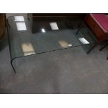 A contemporary glass coffee table.