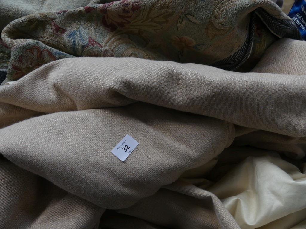 A set of curtains Of beige colour, with gathered detail to top.