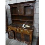 An 18th Century style oak welsh dresser With high back above an arrangement of three drawers and