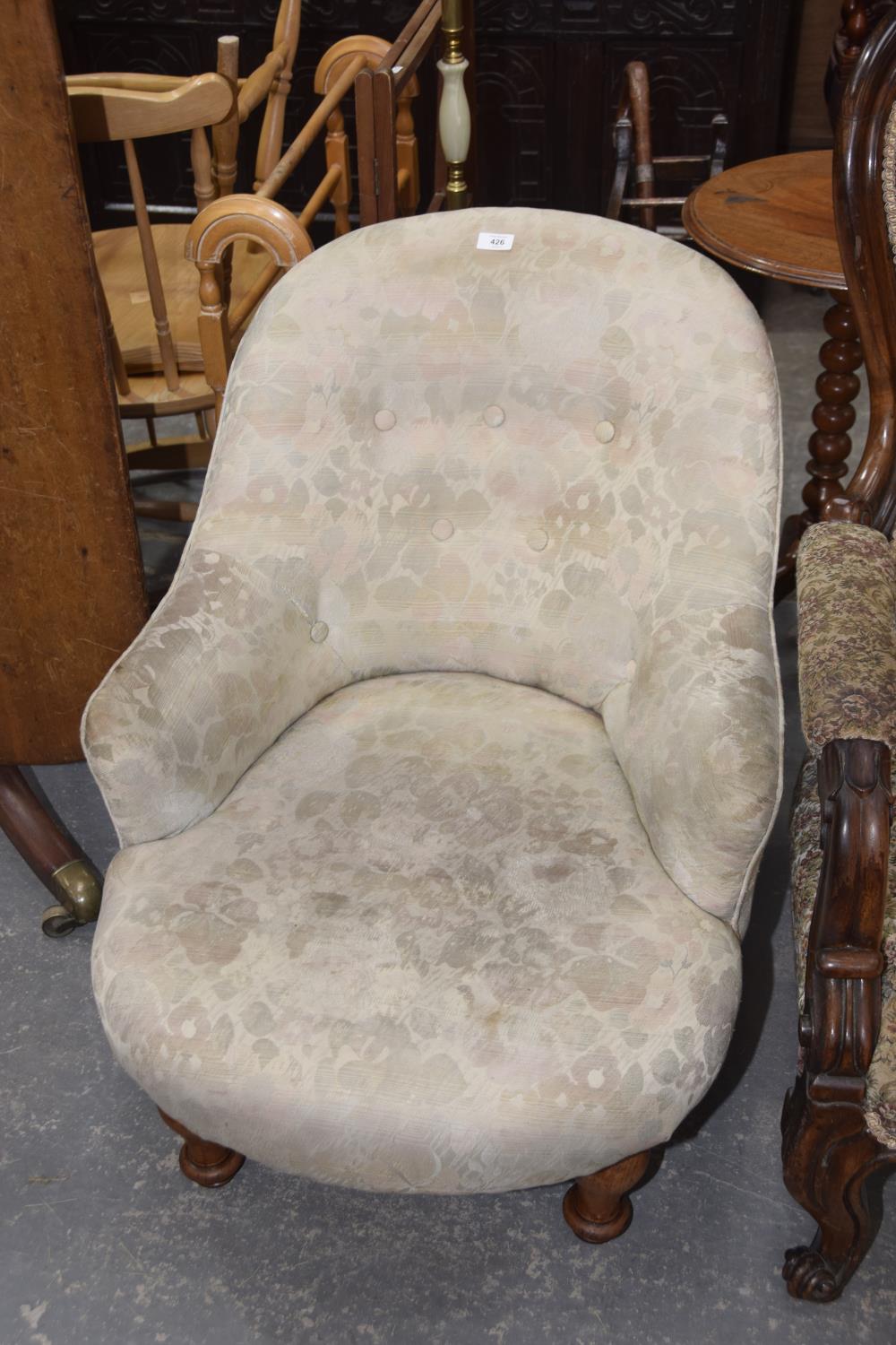 A Victorian button back low seat tub chair.