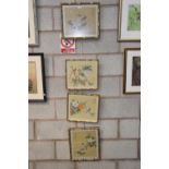 Four various Chinese paintings on rice paper each depicting a bird perched on a flowering branch.