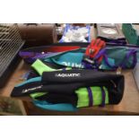 A cased pair of Aquatic sport water skies and an Aquatic sport wet suit.