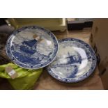 Two 20th Century Delft ware blue and white transfer decorated wall plaques, the first depicting a