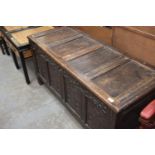 A 17th/18th Century oak blanket chest with four carved panels.