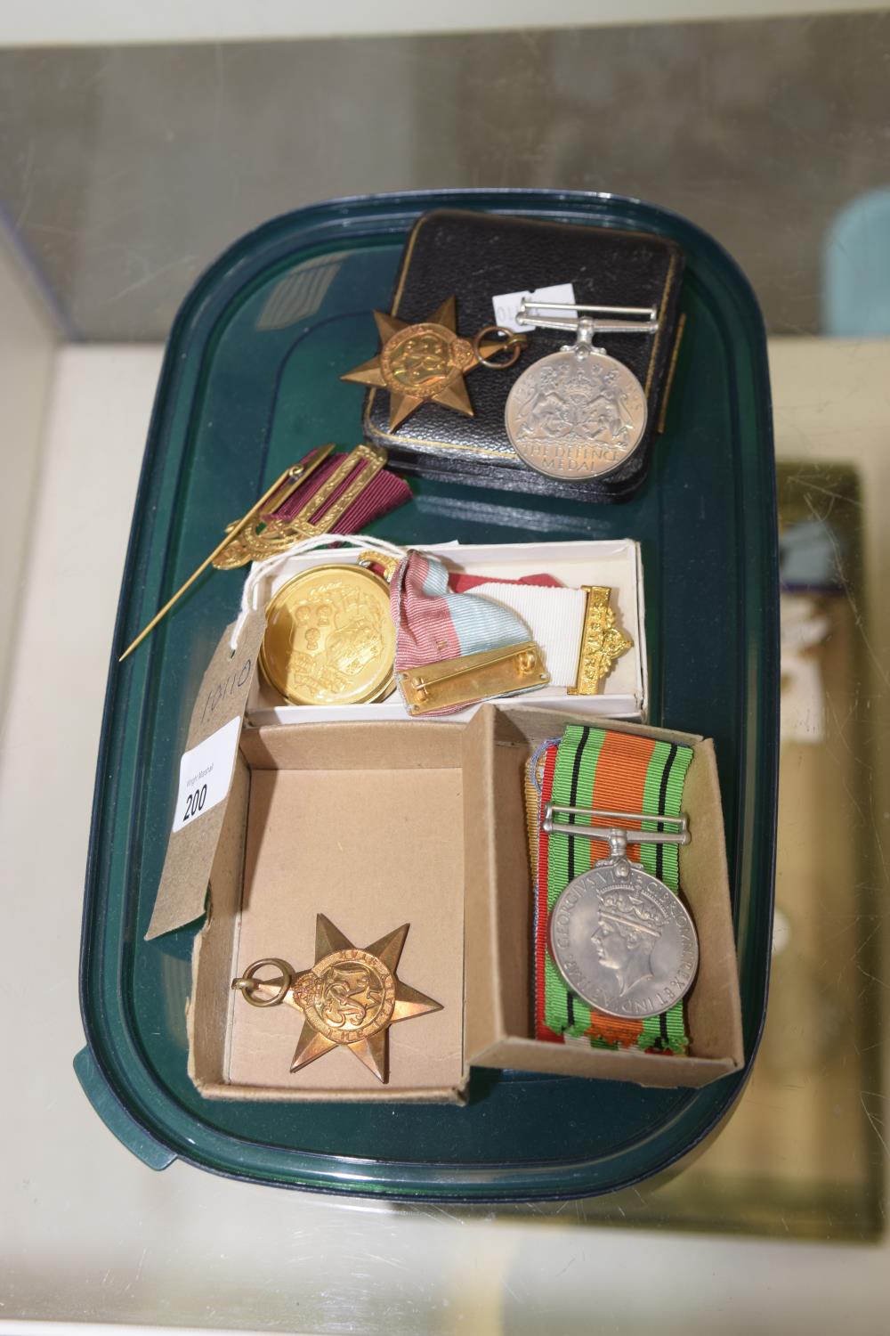 A Collection of medals and ribbons to include The Italy Star , Defence medal and masonic medals .