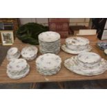 A French GDA porcelaneous floral pattern part dinner service To include tureens, dinner plates, soup