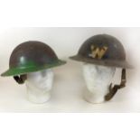 A WWII period black painted brodie wardens helmet Complete with inner lining, further green