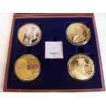 A cased set of the 'Golden Giants' issued by Windsor Mint, comprises four oversized gilt metal