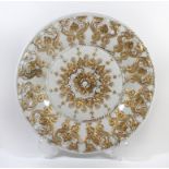 A Meissen circular dish Decorated with a border of gilt highlighted dolphins and a stylised star