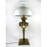 An early 20th Century brass oil lamp Converted to electricity, having circular oil reservoir