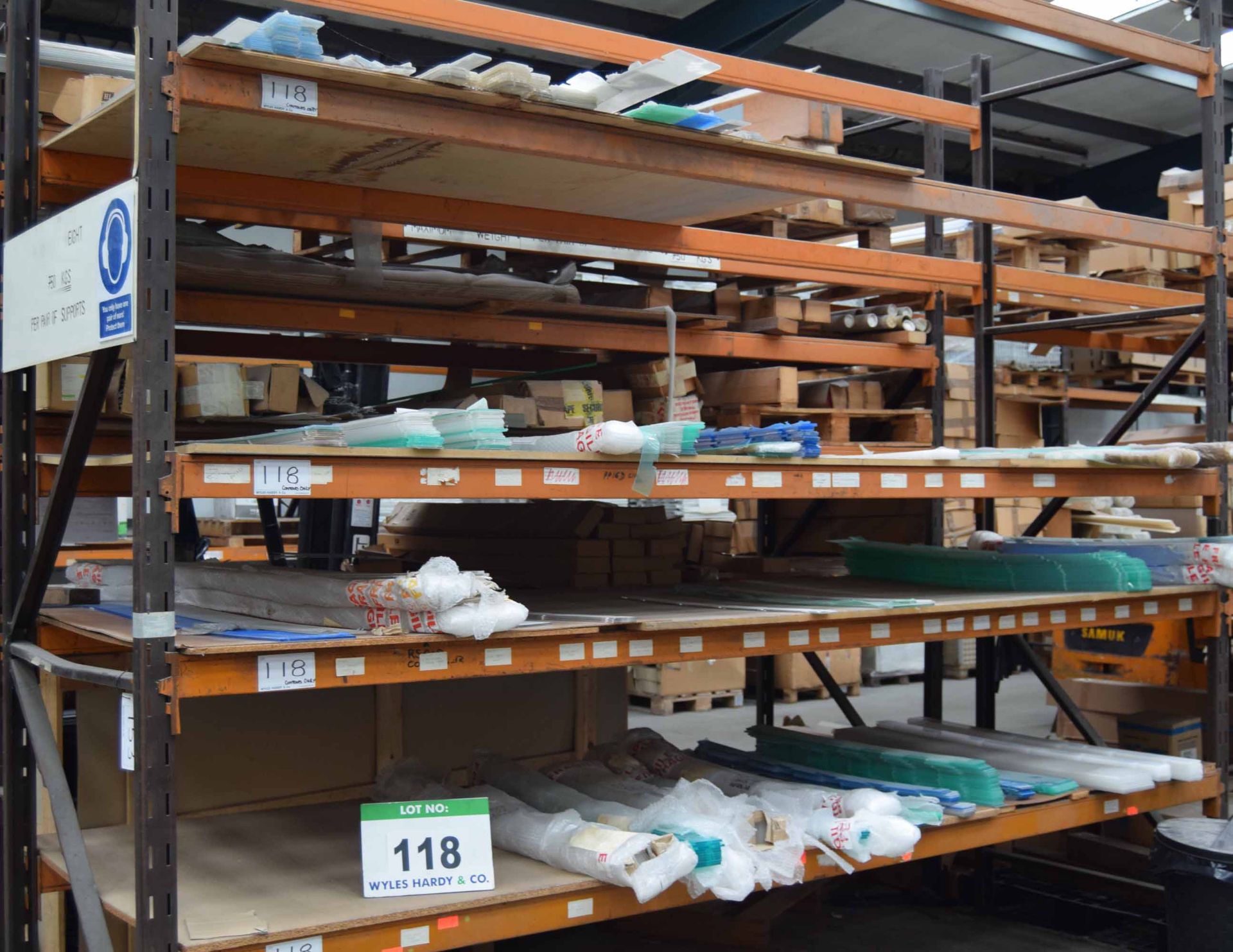 A Quantity of Chiller Cabinet Shelf Risers with Contents of Four Shelves (As Photographed)