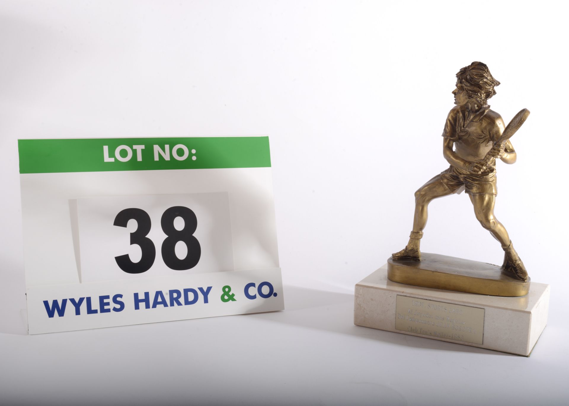 A Tennis Trophy having a Gold Coloured Resin Figure of a Tennis Player on a Composite Marble