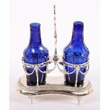 AUGSBURGER EMPIRE-MENAGE, getrieben und gegossen, zwei blaue Glasflaschen mit Zierschliff, H 25,