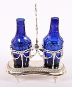 AUGSBURGER EMPIRE-MENAGE, getrieben und gegossen, zwei blaue Glasflaschen mit Zierschliff, H 25,