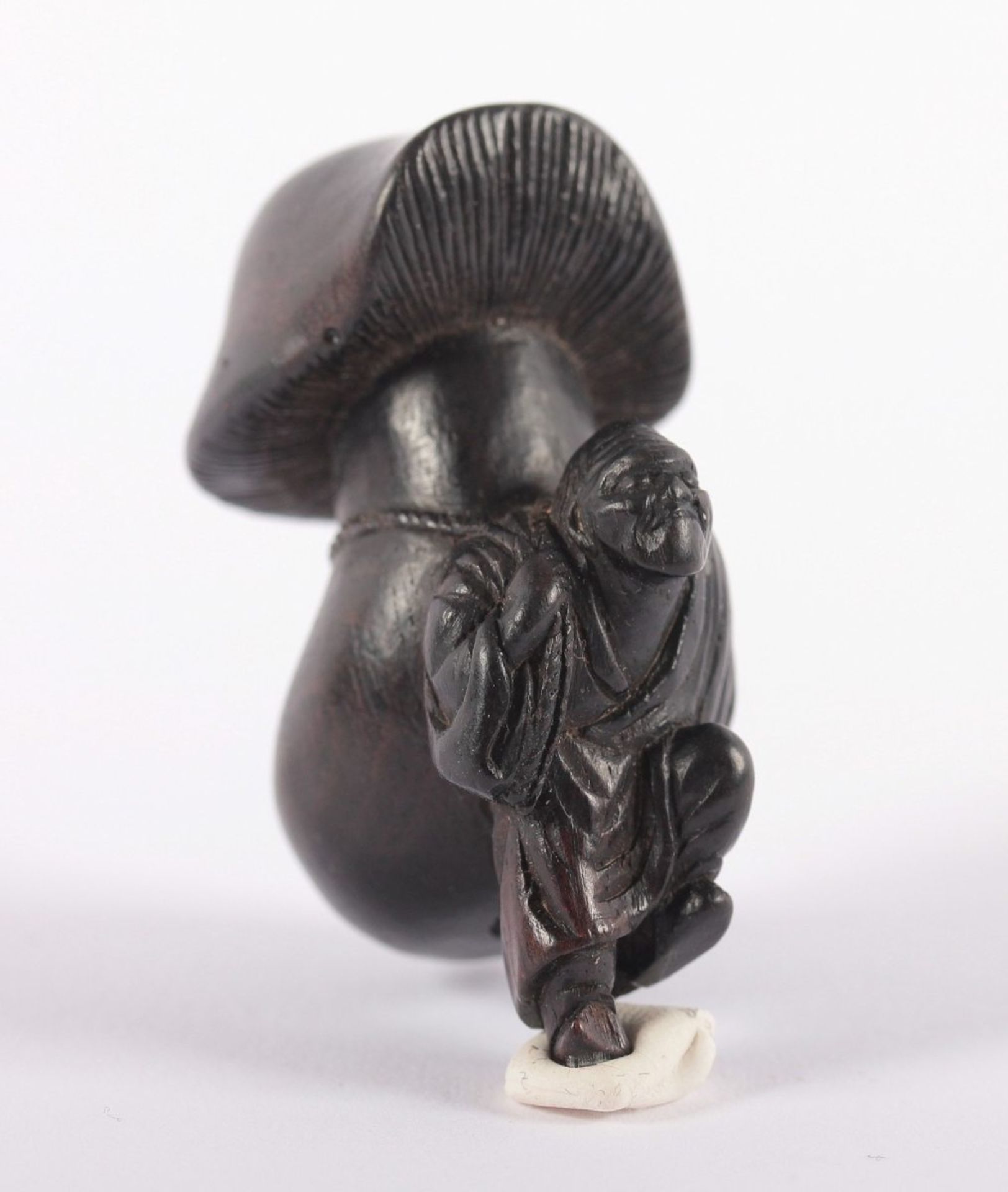 NETSUKE MANN MIT PILZ, schwarzes Holz, ein Mann hat einen riesigen Pilz in phallischer Form auf