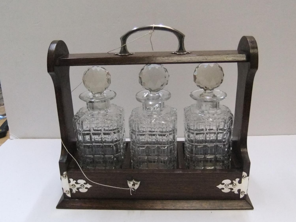 3 bottle antique, early 20thC tantalus complete with key 36 cm in length The bottles all have