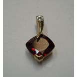 9ct yellow gold & garnet pendant below a clear stone