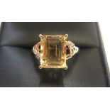 9ct yellow imported gold ring set with a large octagon cut citrine with a single diamond set to each